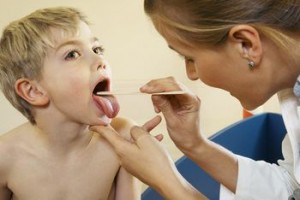 Doctor Examining Boy's Throat
