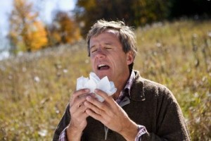 Man Sneezing in Meadow